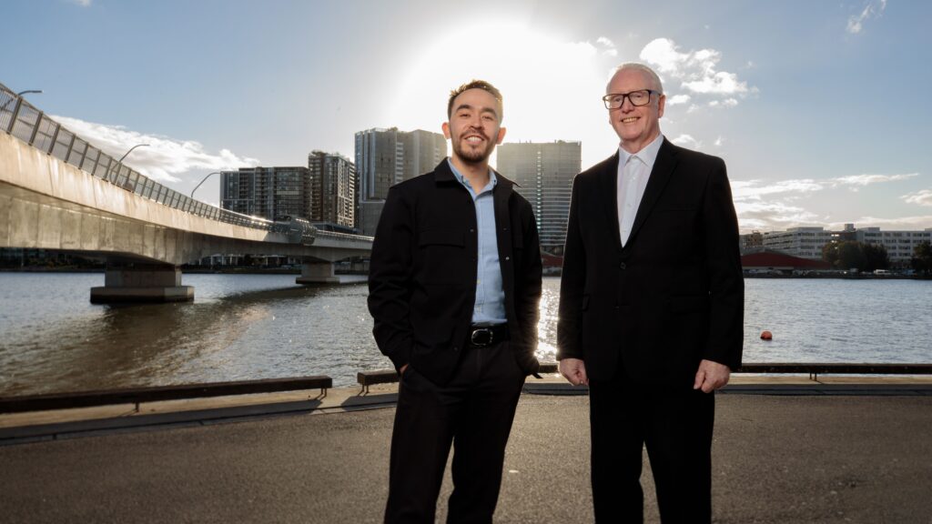 Joseph and Rick standing next to Bennelong Bridge