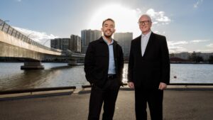 Joseph and Rick standing next to Bennelong Bridge